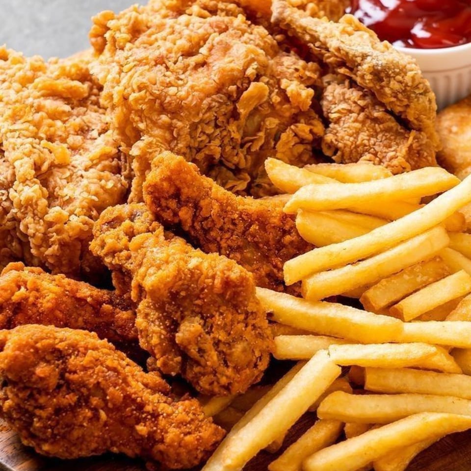 Crispy fried chicken pieces and golden french fries with a side of ketchup.